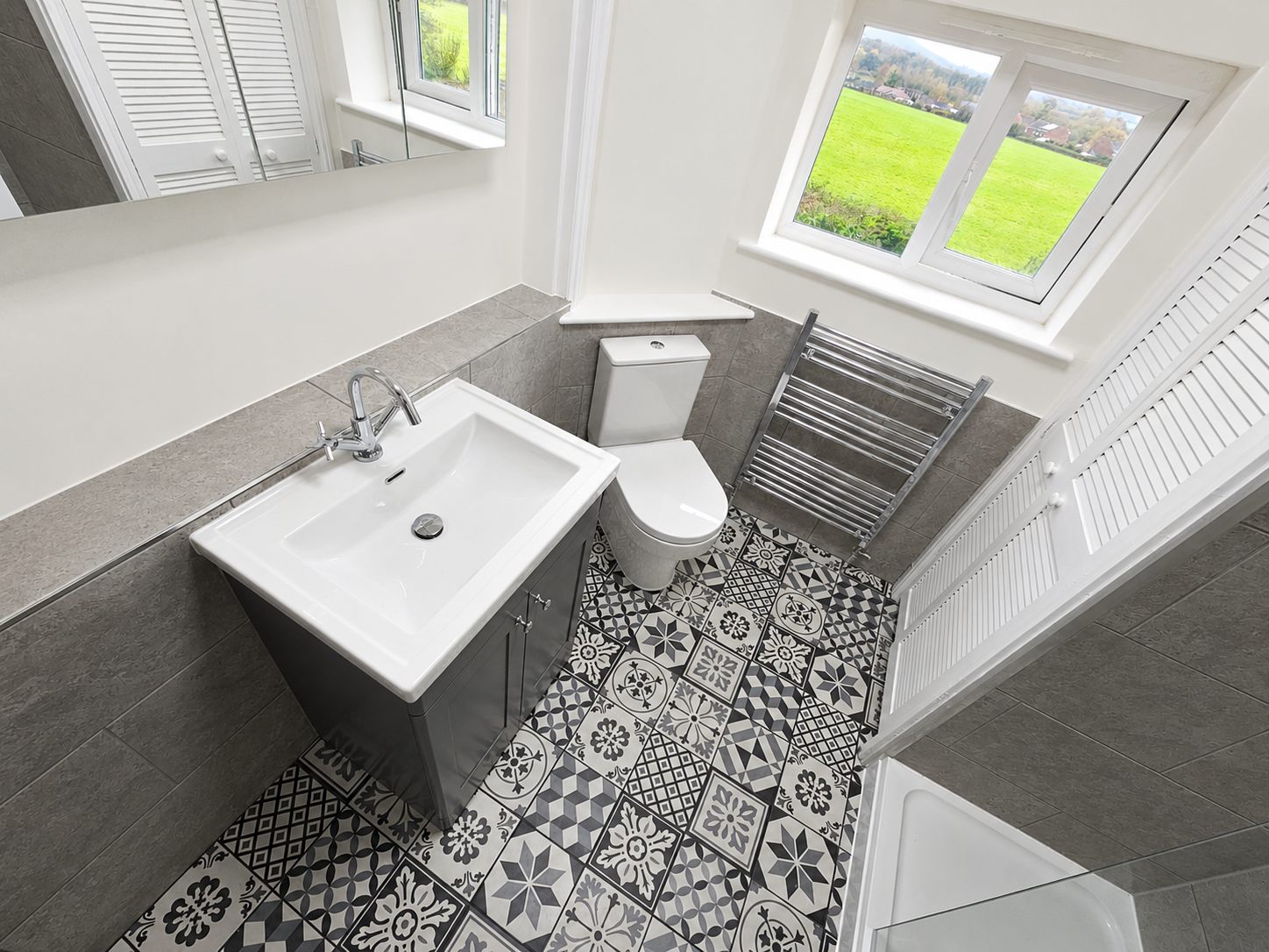 Bathroom vanity, toilet and black-and-white patterned floor